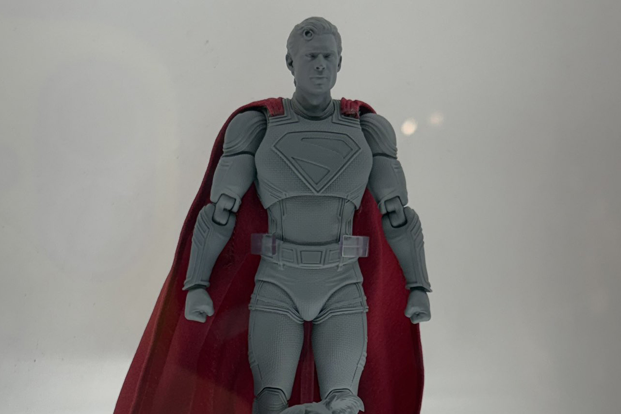 Unpainted prototype of the upcoming DC MAFEX Superman action figure featuring the David Corenswet likeness and red fabric cape.